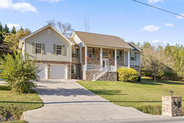 bi-level home featuring a porch, a garage, and a front lawn