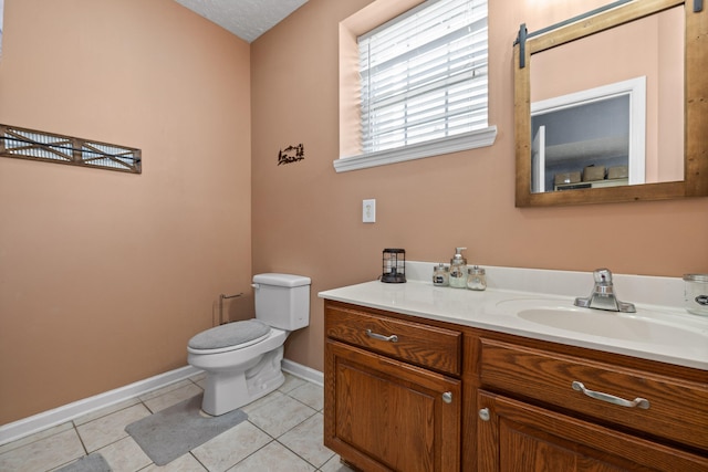 bathroom with tile patterned flooring, vanity, toilet, and a textured ceiling