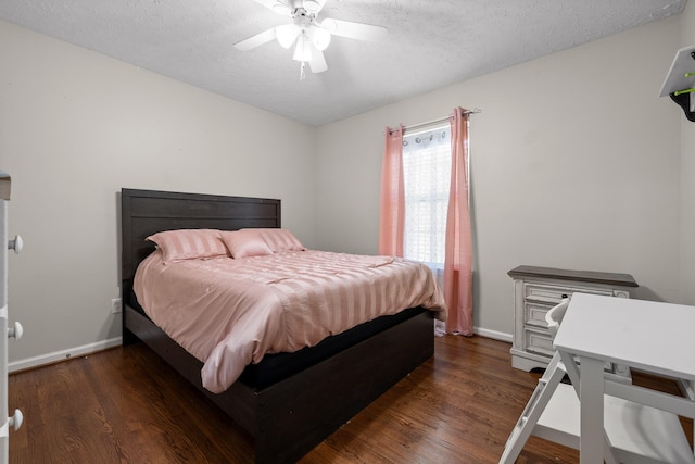 bedroom with a textured ceiling, ceiling fan, and dark wood-type flooring