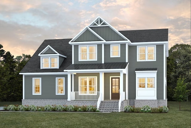 view of front of property with a lawn and covered porch