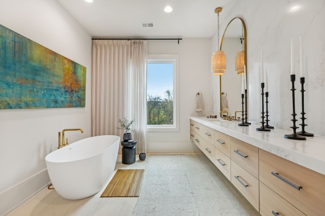 bathroom featuring a tub and vanity