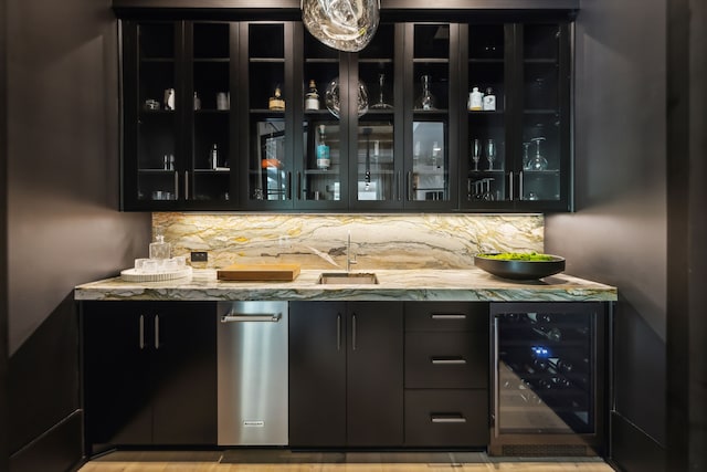 bar with light stone counters, backsplash, and beverage cooler