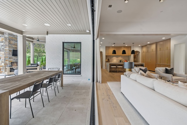 interior space with ceiling fan, light hardwood / wood-style flooring, and wooden ceiling