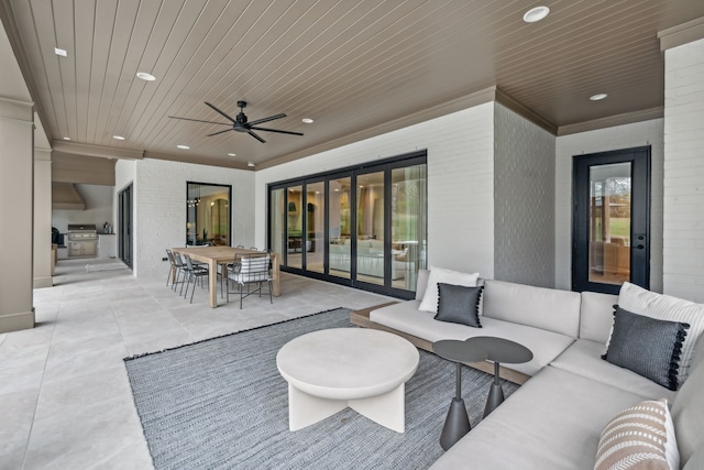 view of patio with an outdoor living space and ceiling fan