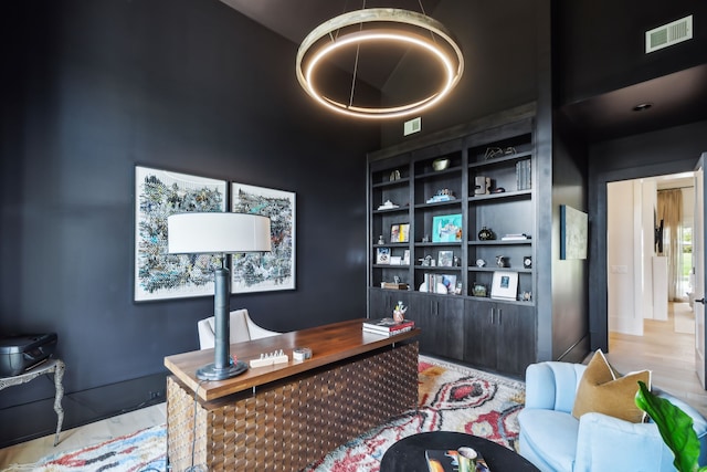 home office with light hardwood / wood-style floors