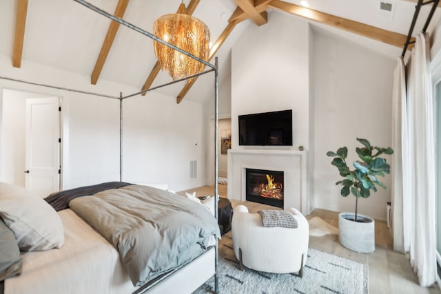 bedroom featuring beamed ceiling and high vaulted ceiling