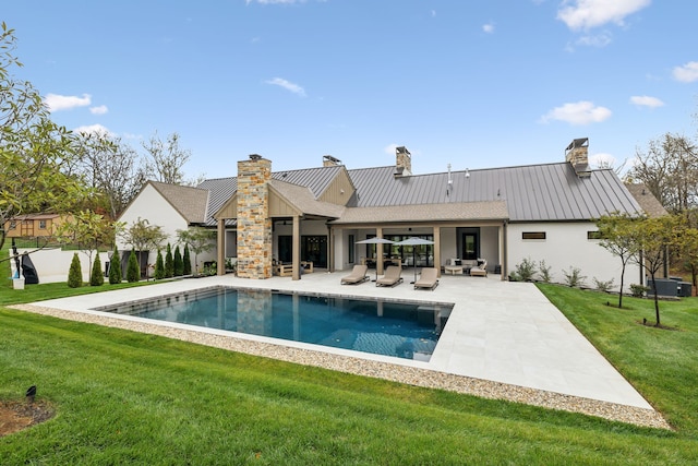 back of house featuring a yard, a patio, and an outdoor hangout area