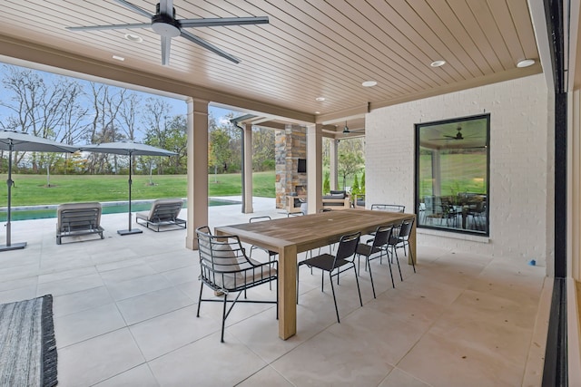 view of patio / terrace featuring ceiling fan and a swimming pool