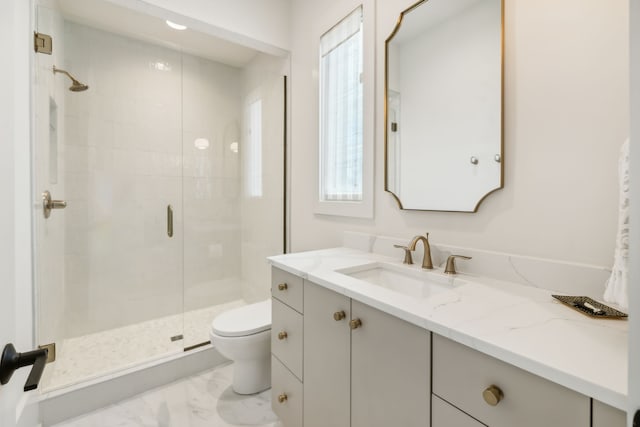 bathroom featuring vanity, toilet, and an enclosed shower