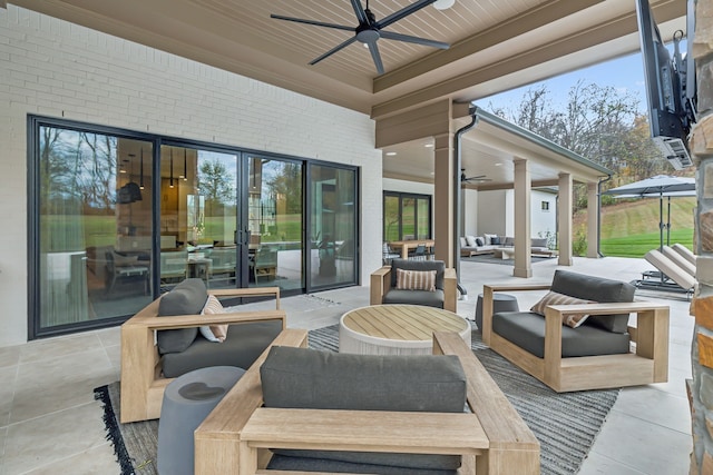 view of patio with an outdoor living space and ceiling fan