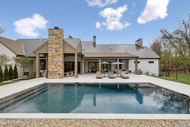 rear view of property featuring a patio area and ceiling fan