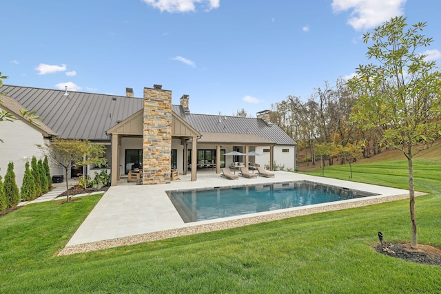 back of house with a yard and a patio