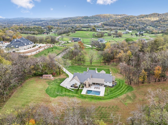 birds eye view of property with a mountain view and a rural view