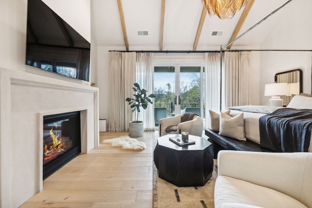 bedroom with light hardwood / wood-style flooring, beamed ceiling, and high vaulted ceiling