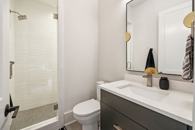 bathroom featuring an enclosed shower, vanity, and toilet