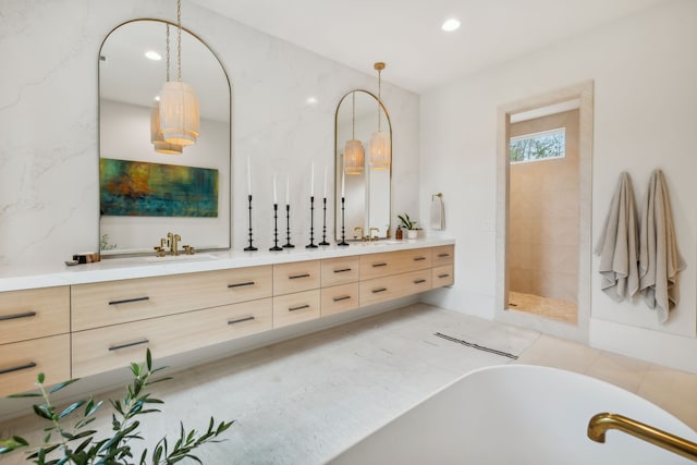 bathroom featuring tile patterned flooring, vanity, and shower with separate bathtub