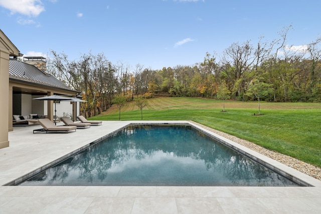 view of pool featuring a yard and a patio