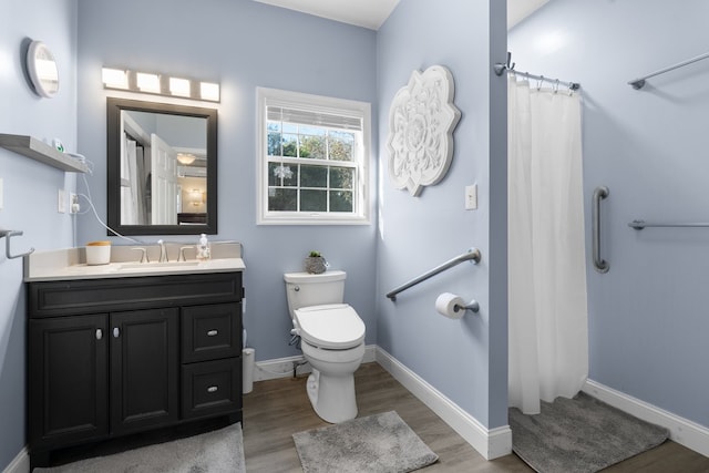 bathroom with vanity, hardwood / wood-style flooring, toilet, and curtained shower