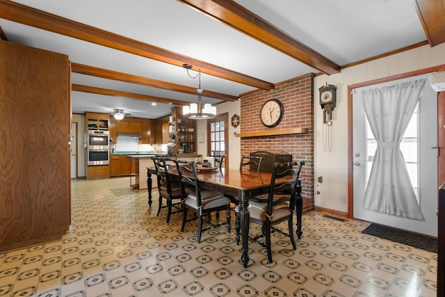 dining area with beam ceiling, ceiling fan with notable chandelier, a wealth of natural light, and crown molding