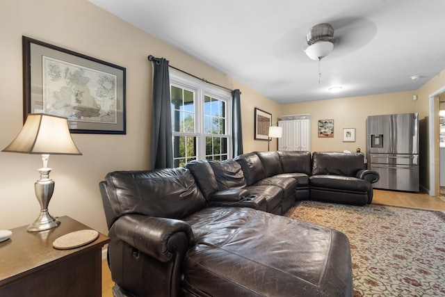 living room with light hardwood / wood-style floors and ceiling fan