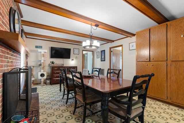 dining room featuring beamed ceiling, a notable chandelier, and brick wall