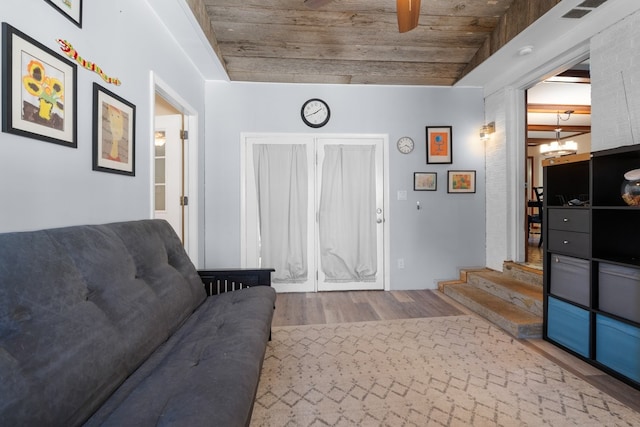 interior space with wood-type flooring and ceiling fan with notable chandelier