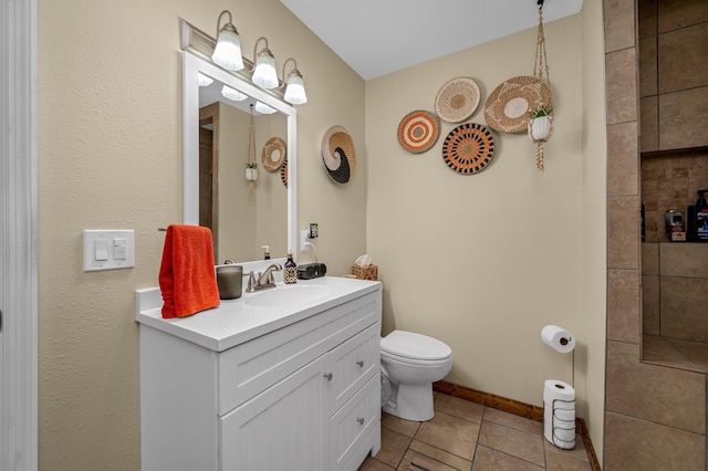 bathroom with tile patterned floors, vanity, and toilet