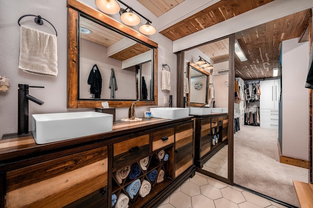 bathroom with an AC wall unit, beamed ceiling, vanity, and wooden ceiling