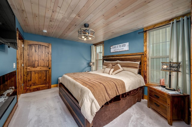 carpeted bedroom featuring wooden ceiling