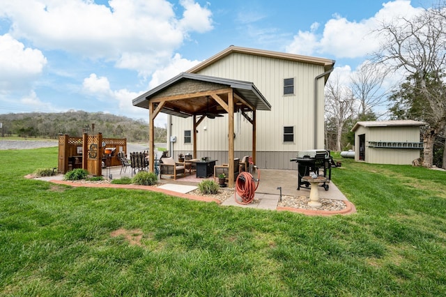 exterior space featuring a lawn, a patio area, an outdoor living space, and ceiling fan