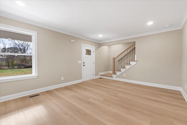 entrance foyer featuring light hardwood / wood-style flooring and ornamental molding