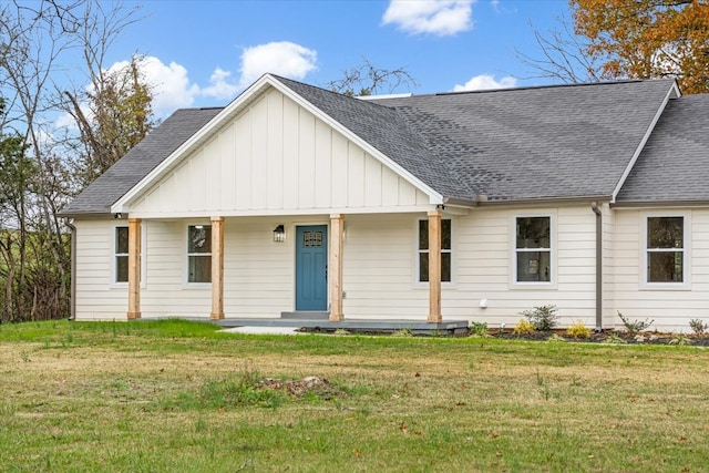 view of front of home with covered porch and a front yard