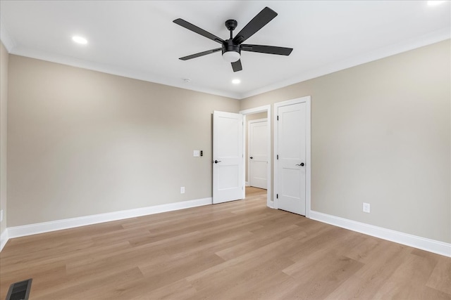 unfurnished bedroom with ceiling fan, light wood-type flooring, and crown molding