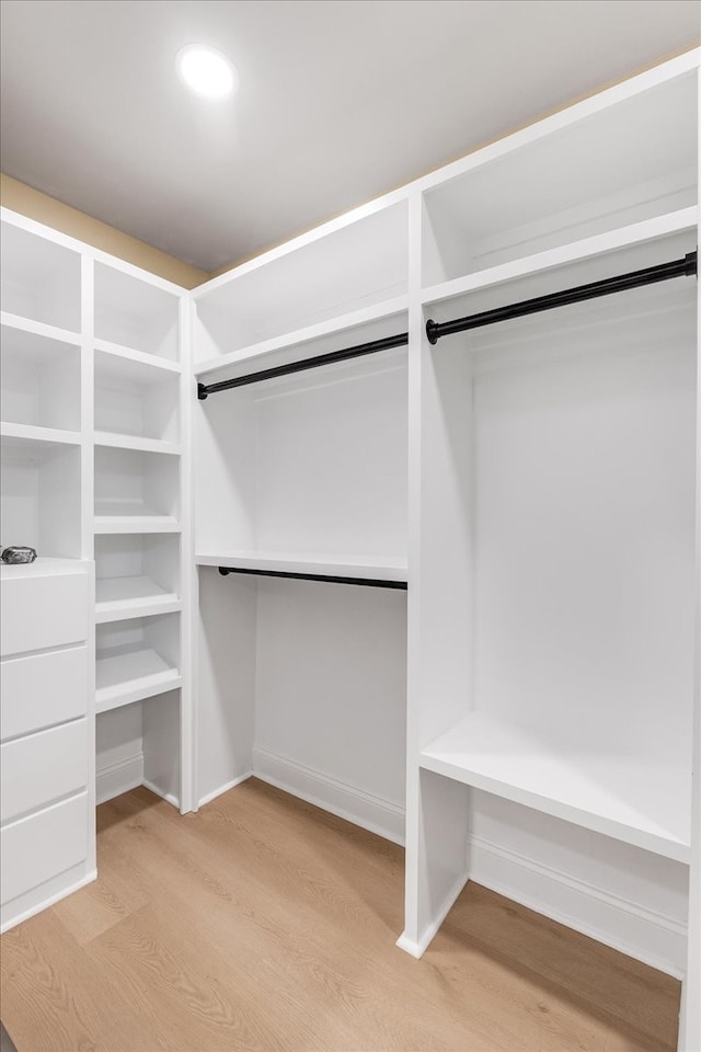 spacious closet with light hardwood / wood-style floors