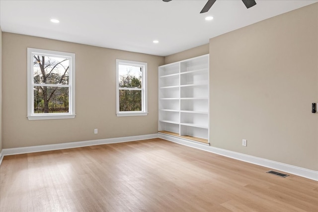 unfurnished room featuring a healthy amount of sunlight and light wood-type flooring