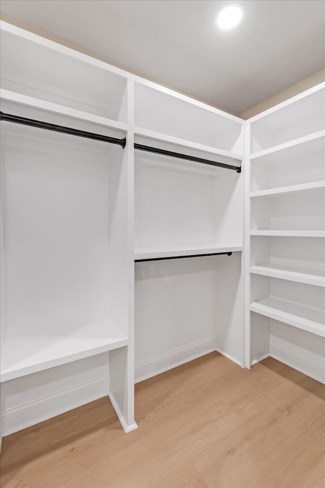 spacious closet featuring hardwood / wood-style floors