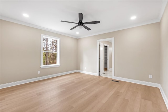 unfurnished room featuring ceiling fan, light wood-type flooring, and crown molding