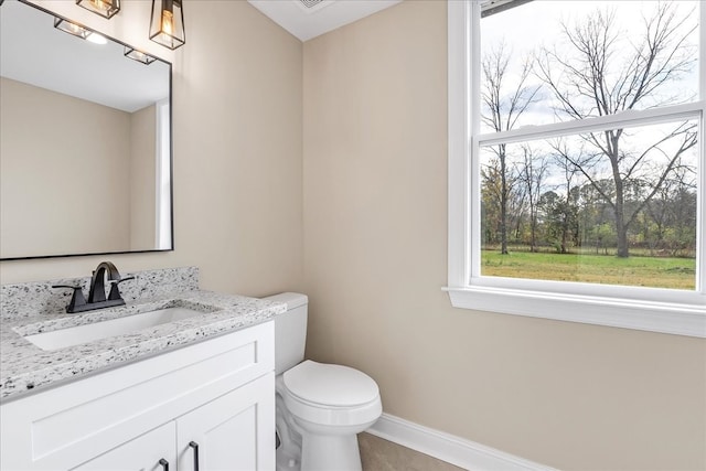 bathroom featuring vanity and toilet