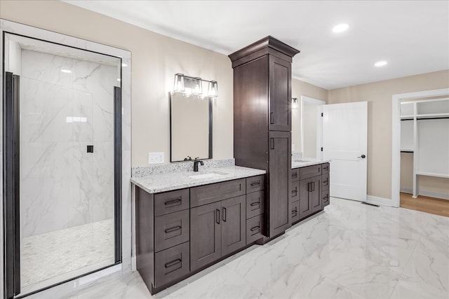 bathroom featuring a tile shower and vanity