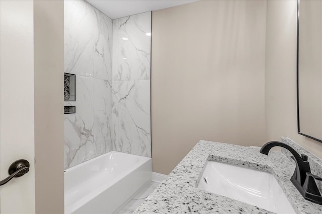 bathroom with vanity and tiled shower / bath combo