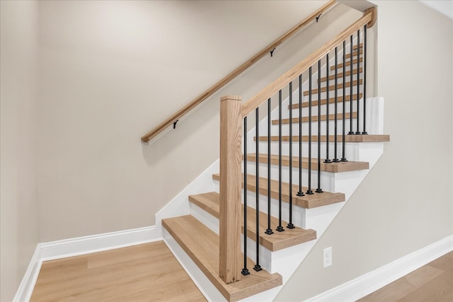 stairs with hardwood / wood-style floors