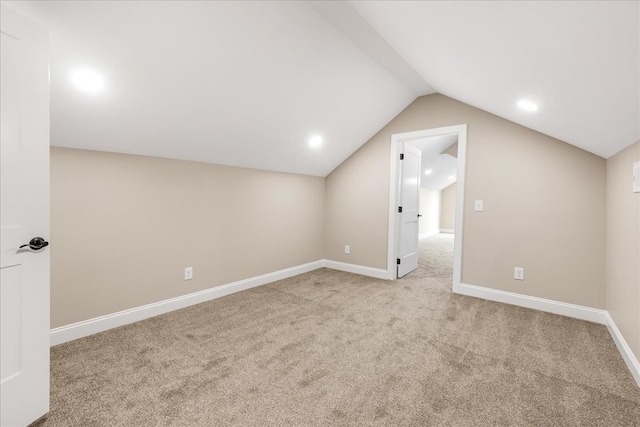 bonus room with light colored carpet and lofted ceiling