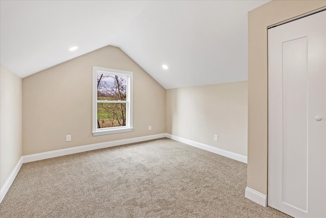 additional living space with light carpet and lofted ceiling