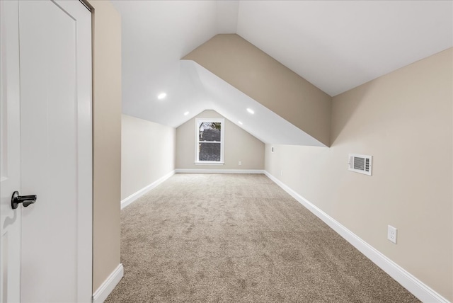 additional living space with carpet and lofted ceiling