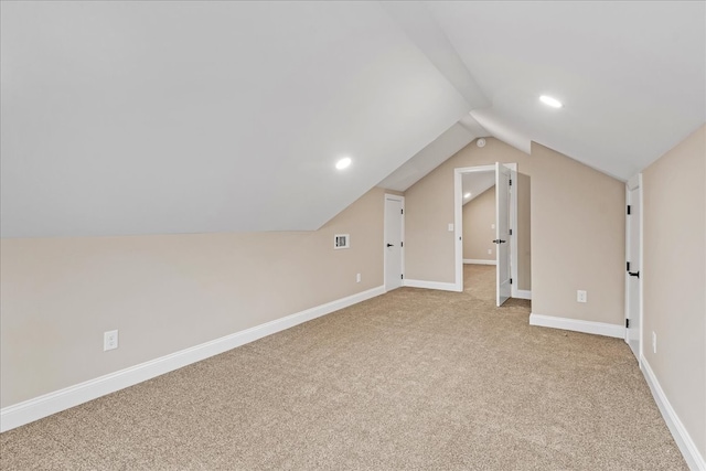 bonus room featuring light carpet and vaulted ceiling