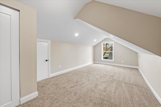 additional living space with light colored carpet and lofted ceiling