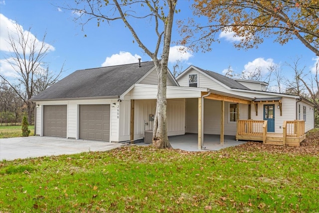 view of front of house featuring a deck, a front yard, and a garage