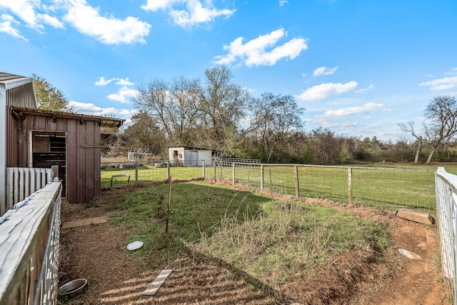 view of yard with a rural view and an outbuilding