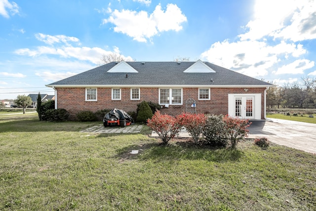 back of house with a lawn and french doors