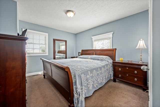 carpeted bedroom featuring a textured ceiling